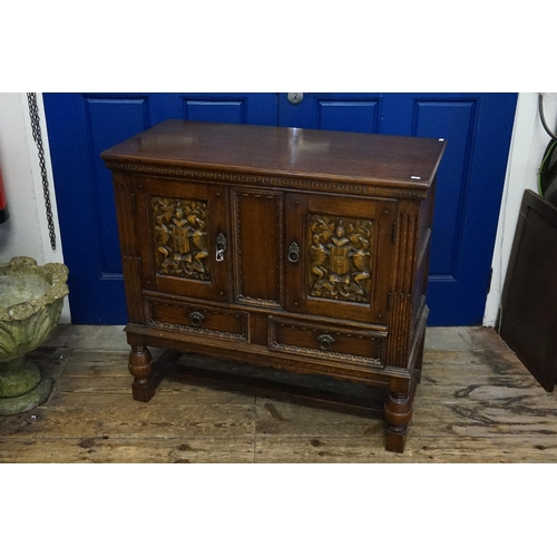 450 - A Reproduction Carved Oak Sideboard fitted with Two Cupboards, Two Drawers & resting on turned bulbo... 