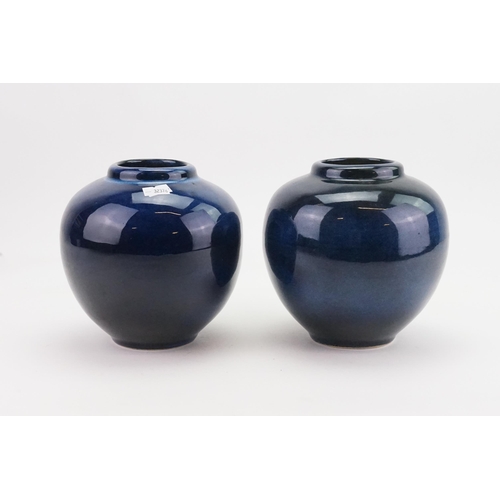 594 - A Pair of Powder Blue Glazed Bulbous Vases. Measuring: 16cms High.