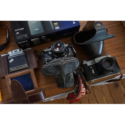 329 - A Zenit B Leather Cased Camera, an Agifold Camera with Flash attachment, a Pentax MX Camera in Case,... 