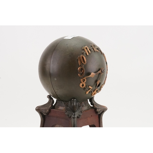 173 - An Art Nouveau Globe Shaped Mantle Clock with Bronze Corners. Standing: 30cms high.