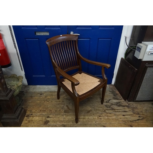 455 - A Edwardian Mahogany Solid Seated Splat Back Kitchen Elbow Chair resting on Square Tapering Back Fee... 