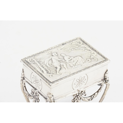 9 - A silver marked casket decorated with scenes of ice skating. Measuring 7.5cm x 7.5cm x 5.5cm. Weight... 