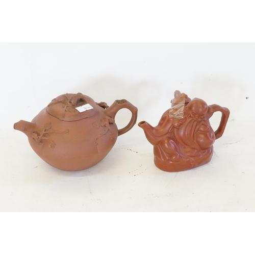 559 - A Chinese Yixing Squat Melon formed Tea Pot decorated with Leaves & one other of a Lo hung with seal... 