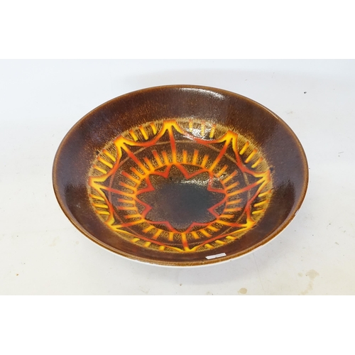 691 - A Circular Poole Pottery Brown Glazed Bowl. (AF). Measuring: 34cms across.