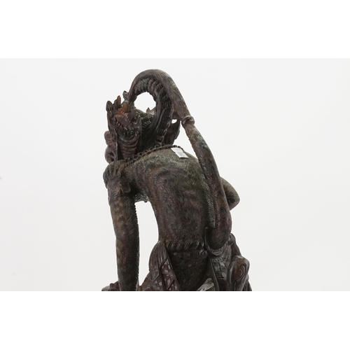 709 - A Carved Hardwood Study of the Monkey God Killing the Dragon. Measuring: 55cms High.