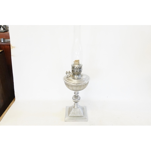 492 - An Oil Lamp in Chrome resting on a Square Base with Fluted Decoration.