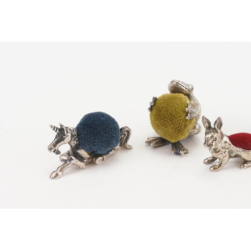 29 - An collection of silver coloured animal shaped pin cushions, to include cat, Silver 925 marked rabbi... 