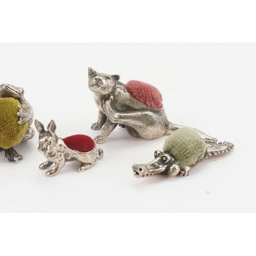 29 - An collection of silver coloured animal shaped pin cushions, to include cat, Silver 925 marked rabbi... 