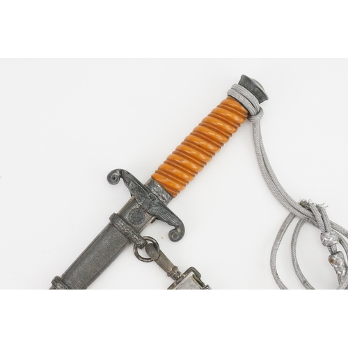 244 - A WWII German officers SS dress dagger, by WKC Solingen. Attached tassel and attachment.