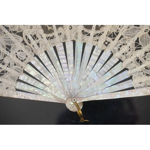 712 - A Victorian Mother of Pearl Fan contained in a Glass Fronted Fan Shaped Frame.