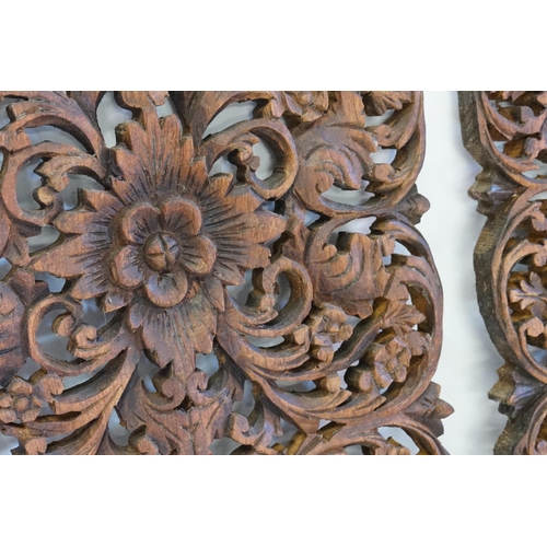 517 - A pair of circa 1930's carved wooden panels, depicting flowers. Measuring: 45cms x 29.5cms.