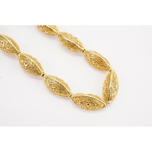 101 - Ex Collection of Mariam Jan (Merjan). A Iranian high carat pierced bead necklace, hung on a 9ct gold... 