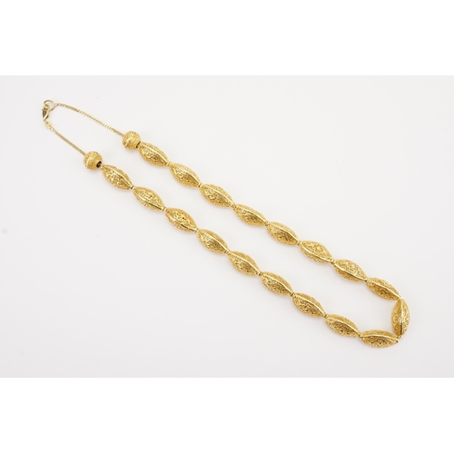 101 - Ex Collection of Mariam Jan (Merjan). A Iranian high carat pierced bead necklace, hung on a 9ct gold... 