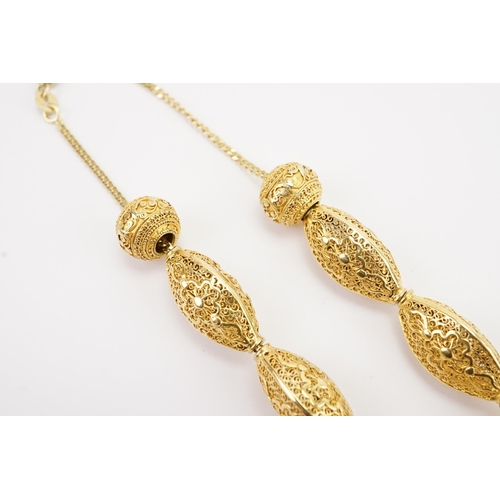 101 - Ex Collection of Mariam Jan (Merjan). A Iranian high carat pierced bead necklace, hung on a 9ct gold... 