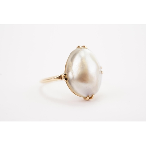 124 - A high carat gold pearl set ring, set with a large pearl, possibly from the Suwaidi farm. (No. 9).