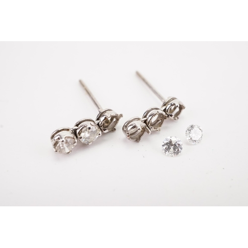 123 - A pair of diamond set earrings, earrings missing two diamonds. Weight 1g. Diamond size approx 0.15ct... 