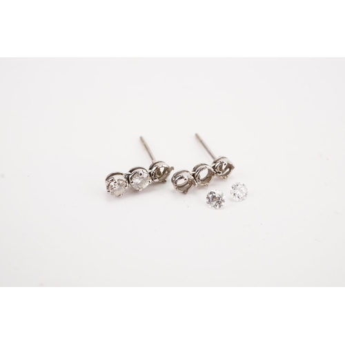 123 - A pair of diamond set earrings, earrings missing two diamonds. Weight 1g. Diamond size approx 0.15ct... 