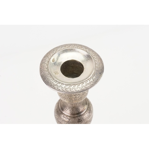 48 - A Iranian Silver Candlestick Holder decorated with various Scenes. Weighing: 302 grams.