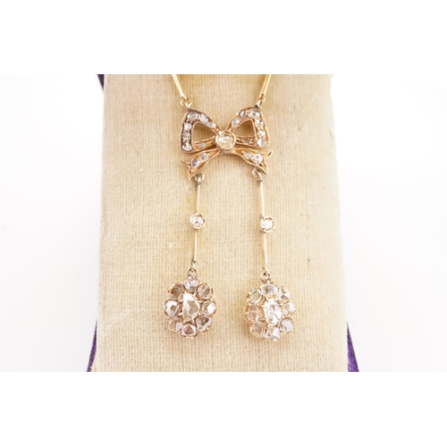 97 - A high carat gold rose cut diamond set necklace, circa 1890's Victorian bow natural diamond set pend... 