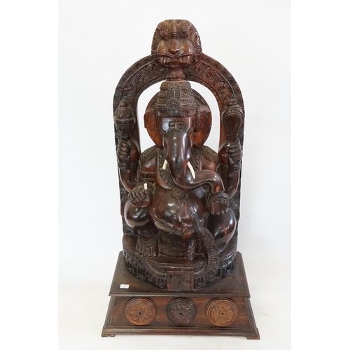 544 - A Carved Indian Hardwood Study of Ganesh in a Arbour with Pot Belly & resting on a Wooden Plinth. Me... 