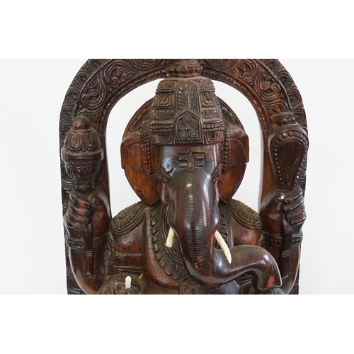 544 - A Carved Indian Hardwood Study of Ganesh in a Arbour with Pot Belly & resting on a Wooden Plinth. Me... 