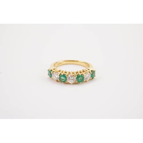 153 - A 18ct gold modern diamond and emerald set band, stone size approx 0.2ct. Set with 3 diamonds and fo... 