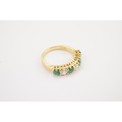 153 - A 18ct gold modern diamond and emerald set band, stone size approx 0.2ct. Set with 3 diamonds and fo... 