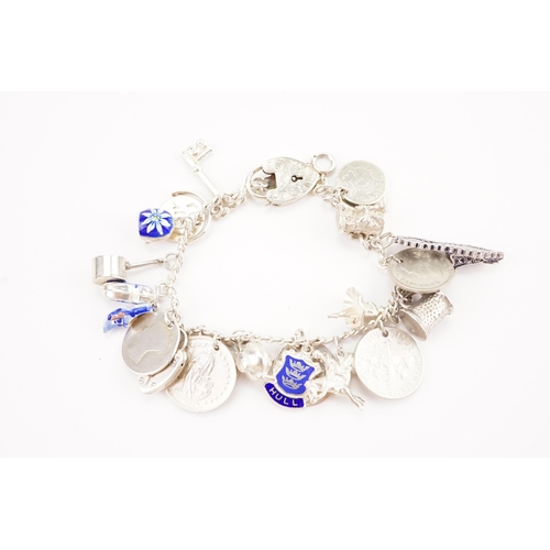 159 - A silver charm bracelet hung with various interesting charms, to include a love heart padlock, ename... 