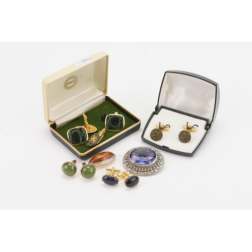 243 - A collection of costume jewellery, to include cufflinks and two stone set brooches.