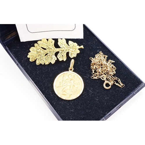 151 - A 22ct plated leaf along with a 9ct gold St Christopher pendant, along with a 9ct gold chain. Weight... 