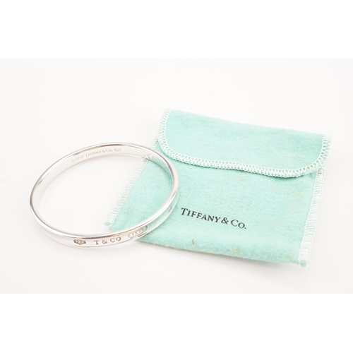 167 - A 1997 Tiffany & Co silver bangle in pouch.