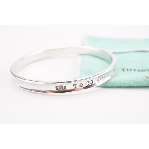 167 - A 1997 Tiffany & Co silver bangle in pouch.