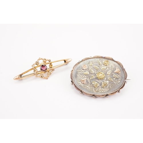 174 - A 9ct gold garnet set brooch, along with a silver mourning brooch.