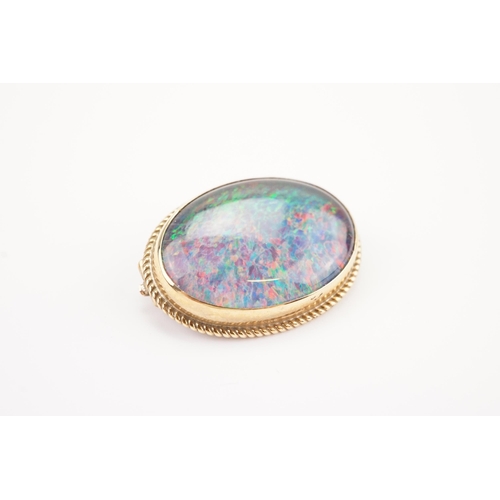 115 - A 9ct Gold mounted Opal Doublet Brooch with an Onyx back. Opal Size: 23mm x 16.5mm. Weighing: 5.8 gr... 