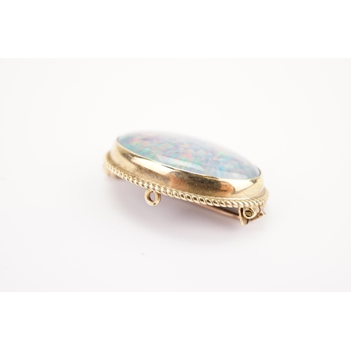 115 - A 9ct Gold mounted Opal Doublet Brooch with an Onyx back. Opal Size: 23mm x 16.5mm. Weighing: 5.8 gr... 