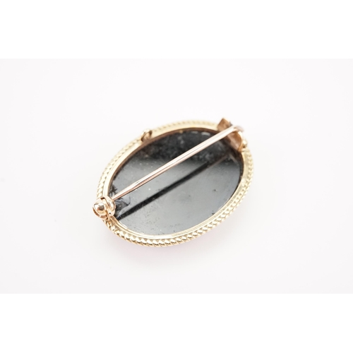 115 - A 9ct Gold mounted Opal Doublet Brooch with an Onyx back. Opal Size: 23mm x 16.5mm. Weighing: 5.8 gr... 