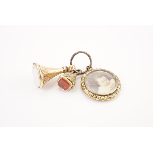 215 - A two Victorian seals mounted with a carnelian and white stone, along with a photograph charm. Weigh... 