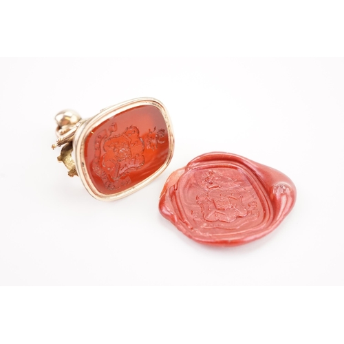 218 - A Georgian intaglio seal, mounted with a carnelian stone, depicting a family coat of arms. Weight 13... 