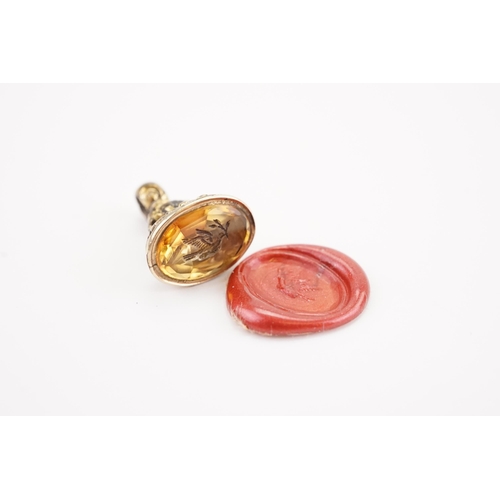 219 - A Victorian intaglio seal, mounted with a citrine depicting a dove and mistletoe. Weight 2.3g. Heigh... 