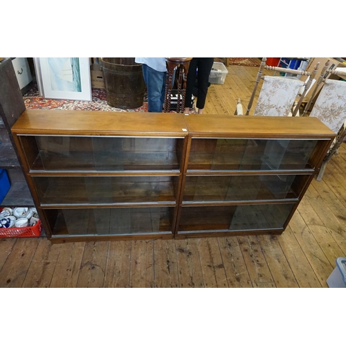 576 - A Pair of Mahogany Glass Sliding Door Fronted Book Cases standing on square feet. Measuring: 90cms a... 