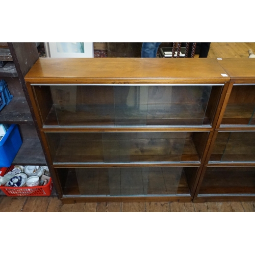 576 - A Pair of Mahogany Glass Sliding Door Fronted Book Cases standing on square feet. Measuring: 90cms a... 