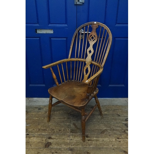 581 - A Victorian Wheel & Splat Back Windsor Chair in Elm & Beech resting on Turned Legs & Cross Stretcher... 