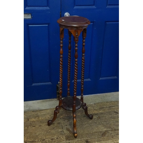 588 - A Reproduction Mahogany Jardiniere Stand resting on Barley Twist Legs. Measuring: 105cms high.