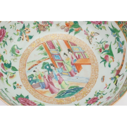 442 - A Chinese Cantonese Enamel Punch Bowl decorated with an interior scene of young girls in a garden se... 