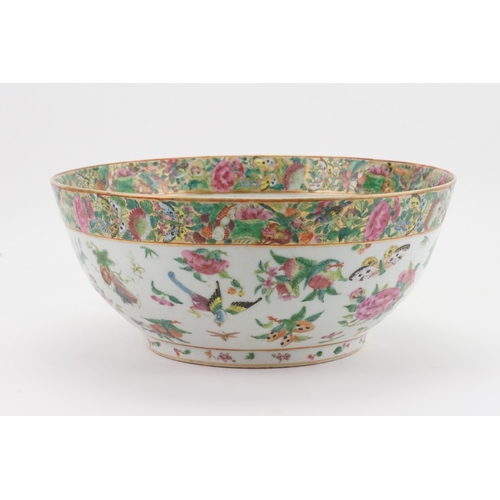 442 - A Chinese Cantonese Enamel Punch Bowl decorated with an interior scene of young girls in a garden se... 