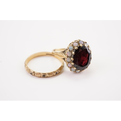 181 - Two 9ct gold dress rings, to include a garnet and opal set ring, along with a band. Weight 6.5g.