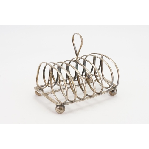 71 - A Georgian silver 1825 Thomas Blagden & Co large toast rack, resting on ball feet. Weight 407g.