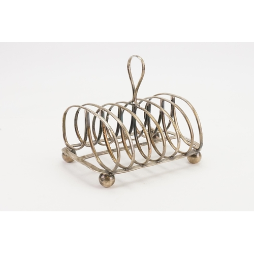 71 - A Georgian silver 1825 Thomas Blagden & Co large toast rack, resting on ball feet. Weight 407g.