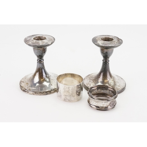 74 - A pair of Silver candlesticks and two silver napkin rings. (weight: 42g.)