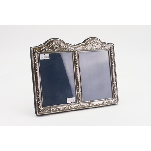 61 - A 1991 Sheffield silver embossed photo frame, by Carr's of Sheffield. Size 22cm x 17cm.